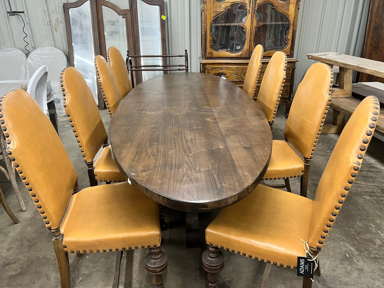 Round Pedestal Dining Table with Tan Leather Wing Chairs